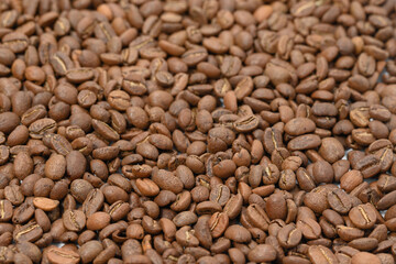Spilled roasted coffee beans, place for Copy space.