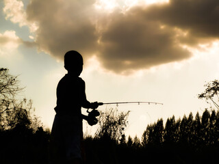 silhouette of a child fishing children s happy time in the
