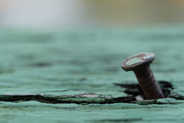 rusty nail on old wood background with soft focus closeup