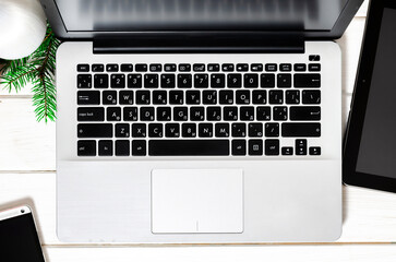 Laptop, smartphone and tablet on a white wooden table. Online shopping