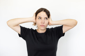 Woman rolling her eyes and covering hear ears with hands. Caucasian woman having no desire to listen conversation, unsolicited advice or opinion. Negative emotion, expression, gesture concept