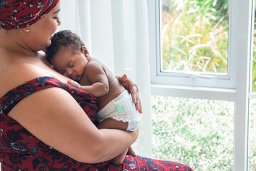 Baby half Nigerian half Thai, is 2-month-old baby newborn son, sleeping and happiness with his...
