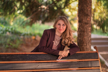 Portrait of a young beautiful fair-haired girl in a summer park.