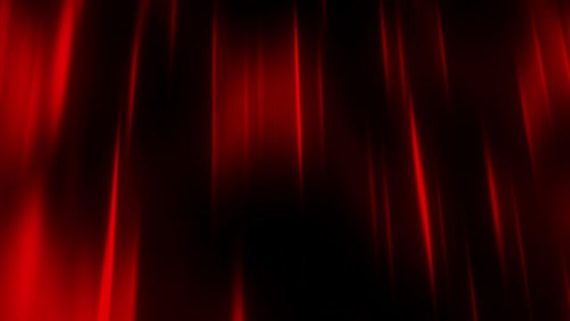 Dark background. Motion. Thin beams of red in the animation scatter slowly in different directions through the darkness.