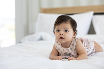 portrait cute baby crawling on bed and looking to something