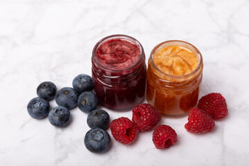 Jar of honey. Fruit honey with raspberries, blueberries, almonds and pistachios. Jams for health and beauty. Honey cream. Organic product of a vegetarian diet. Copy space.Copy space.