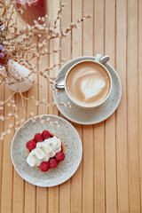 Cappuccino, pink raspberry smoothie, dessert - french sugar free tart among decorative flowers
