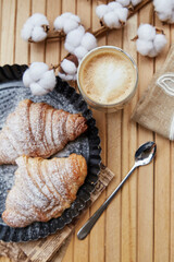 Aesthetic french breakfast with fresh croissants, latte. Autumn coziness. Cotton decoration. Pastel stories background