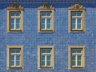 Fototapeta na wymiar Traditional Portuguese houses with windows frame, Seamless pattern of building wall with blue colour made from square ceramic vintage tiles, Architecture background, Lisbon is capital city of Portugal