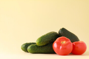 Fresh vegetables on yellow color background. Cucumber tomato. Healthy food concept background. Vegan vegetarian food diet clean eating. space for text copy space