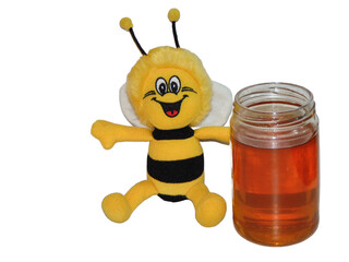 Plush smiling bee and a jar of polyflora honey. Beekeeping concept. Bee toy