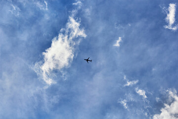Airplane flying, blue sky, white clouds