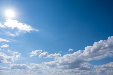 Fototapeta premium Cumulus clouds against the blue sky on a summer day.