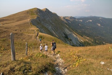Tourists hiking in the Jura mountains, Colomby de Gex massif, France