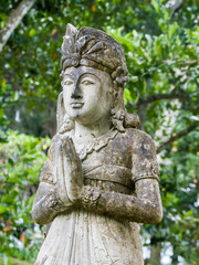 Indonesia, Bali, Ubud. Stone statue in Pura Tirta Empul, the water temple located in the village of Manukayu.