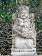 Indonesia, Bali, Ubud. Stone statue in Pura Tirta Empul, the water temple located in the village of Manukayu.