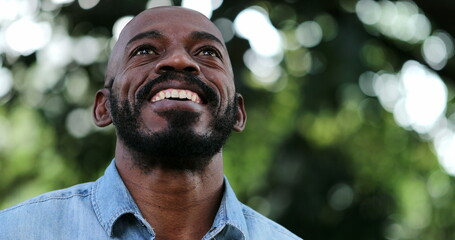 African man taking a deep breath and opening eyes smiling feeling free