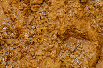 Frozen icy sand texture. Sand covered with ice after freezing rain.