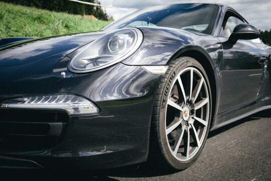 Porsche car close up, brand symbol. Beautiful background with a car.
