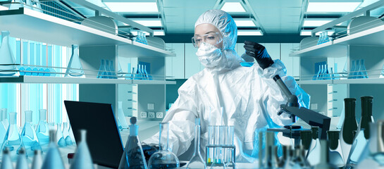 Scientist in chemical laboratory. Woman Chemist in protective suit. Scientist with laptop and...