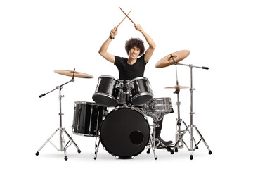 Young male drummer holding drumsticks up - obrazy, fototapety, plakaty