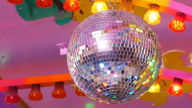Silver disco ball at a party or celebration. Lighting design on the stage of the birthday party in the club. Abstract background of retro disco ball