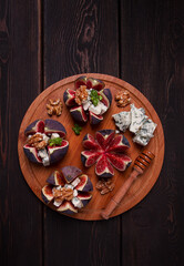 Appetizer, Figs with blue cheese, walnut, honey, on a wooden board, top view, close-up, no people,