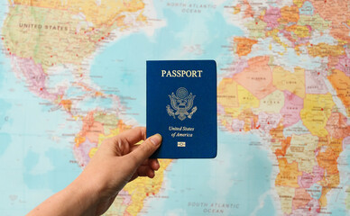 Fototapeta na wymiar United States of America passport in front of world map.