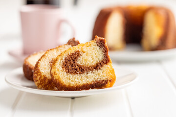 Sweet sponge cake. Bundt cake on plate on white table.