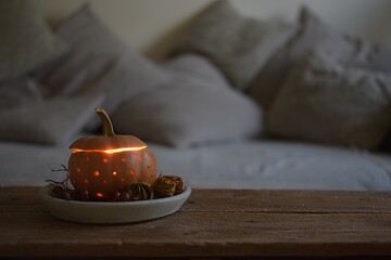 autumn still life in the living room. Halloween decoration, pumpkin, candle