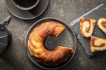 Sweet sponge cake. Bundt cake on dark table.
