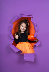 Funny child girl in witch costume in halloween