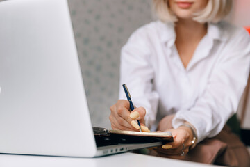 Young blond caucasian woman with glasses coach psychologist working online session on laptop....