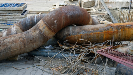 Old rusty metal pipes. Construction work to replace heating pipes. Reconstruction of the cold and...
