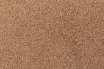 Sample of a texture of brown plaster. Wall finished with a decorative cement stucco. Example of...
