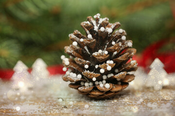 Christmas decoration with pine cones and blurred bokeh lights	