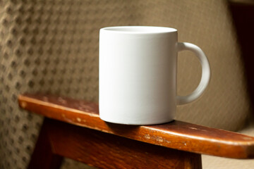 White mug on the armrest of a chair