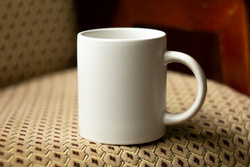 White mug on the chair - 532280841