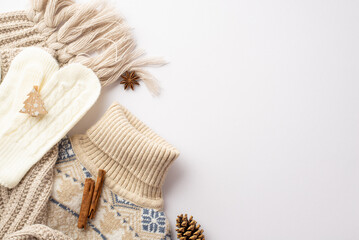 Winter concept. Top view photo of knitted sweater scarf mittens decorative wooden christmas tree shaped clip anise pine cone and cinnamon sticks on isolated white background with empty space