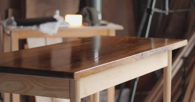Master carpenter. Applying furniture oil to the table. Table top solid walnut