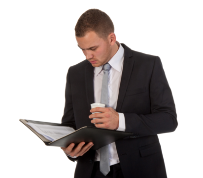 Businessman drinking coffee while reading his documents