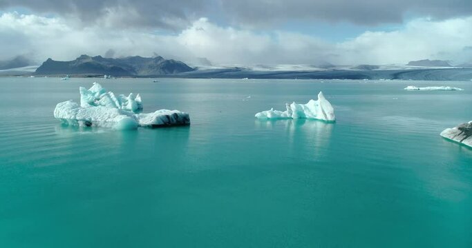 floating arctic icebergs above water in jokulsarlon, Iceland