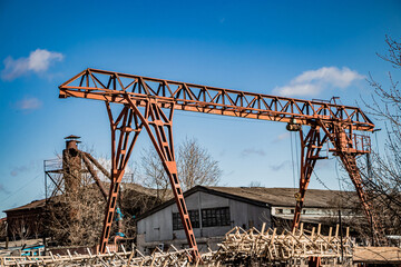 Old rusty gantry crane at abandoned construction site.