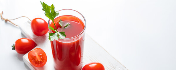 Refreshing tomato juice with herbs on white background. Vegan vegetable drink.