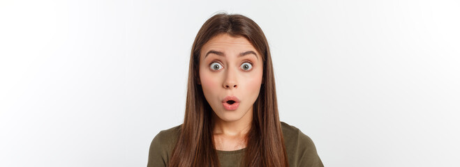 Close-up portrait of surprised beautiful girl holding her head in amazement and open-mouthed. Over...
