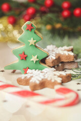 Christmas decoration. Christmas tree branches and homemade decorated Christmas cookies, close up image.	
