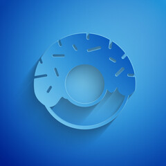 Paper cut Donut with sweet glaze icon isolated on blue background. Paper art style. Vector