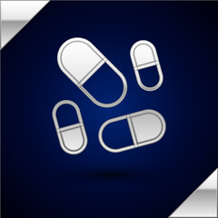 Silver Vitamin complex of pill capsule icon isolated on dark blue background. Healthy lifestyle. Vector