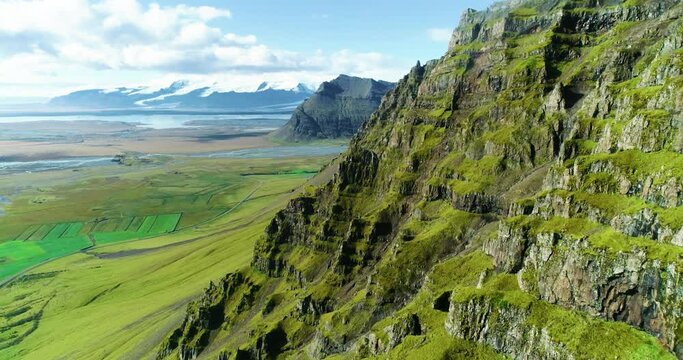 Landscape of enormous mountain made from big layers of black rocks.