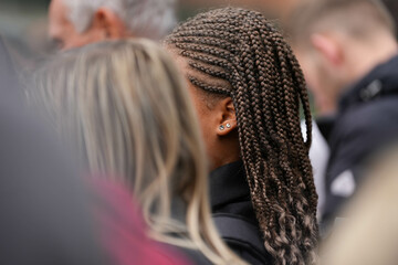 braided hair in pigtails. detail. African hairstyle. - obrazy, fototapety, plakaty